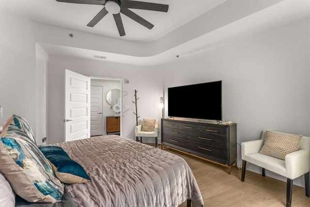 1080 Peachtree St NE Unit 1909, Atlanta, GA 30309 - bedroom featuring a tray ceiling, visible vents, ceiling fan, and light wood finished floors