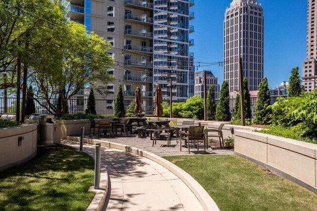 1080 Peachtree St NE Unit 1909, Atlanta, GA 30309 - surrounding community with a lawn, a view of city, and fence