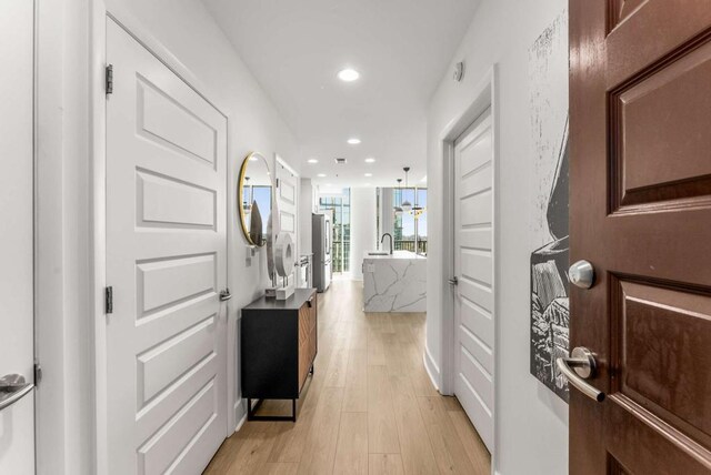 1080 Peachtree St NE Unit 1909, Atlanta, GA 30309 - hallway with recessed lighting, light wood-style floors, and a sink
