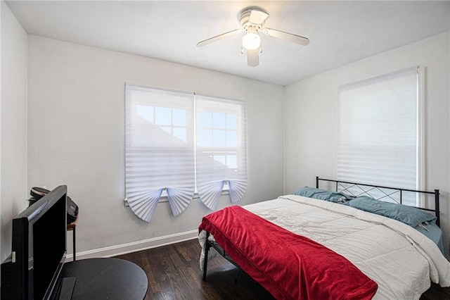 bedroom featuring ceiling fan, baseboards, and wood finished floors