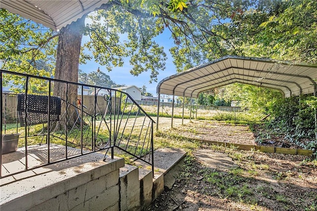 view of yard featuring fence and a detached carport