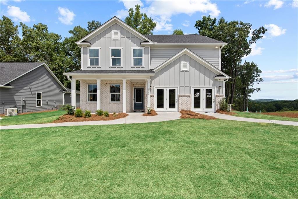 view of front of house with french doors and a front yard