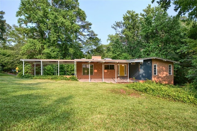 3861 Foxford Dr, Atlanta, GA 30340 - back of house with a yard, a patio, brick siding, and a chimney