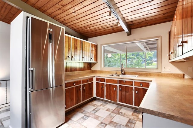 3861 Foxford Dr, Atlanta, GA 30340 - kitchen featuring stainless steel refrigerator, a sink, wooden ceiling with exposed beams, light countertops, and brown cabinetry