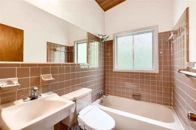 3861 Foxford Dr, Atlanta, GA 30340 - bathroom featuring a sink, toilet, tile walls, and shower / bathtub combination