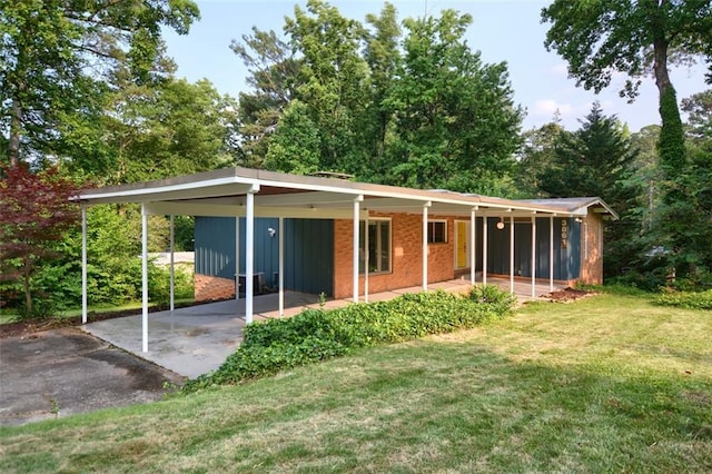 3861 Foxford Dr, Atlanta, GA 30340 - rear view of house featuring a lawn, driveway, board and batten siding, and brick siding