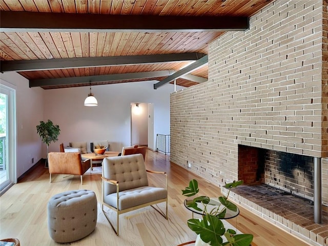 3861 Foxford Dr, Atlanta, GA 30340 - living area featuring light wood-style floors, wooden ceiling with exposed beams, a fireplace, and brick wall