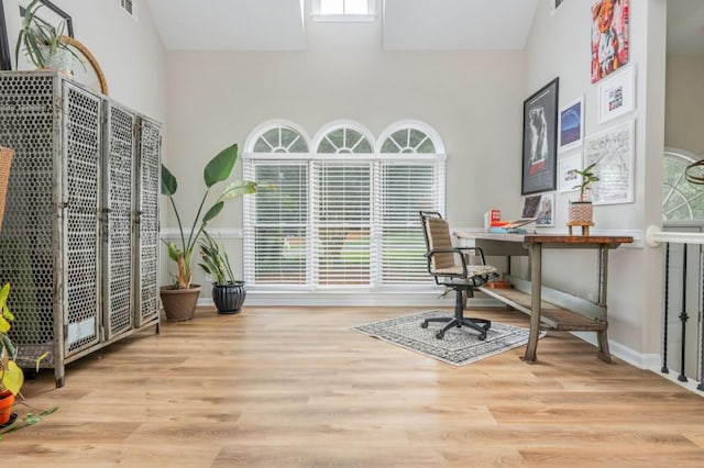2045 Bethany Spring Trce, Cumming, GA 30041 - office area featuring plenty of natural light, a towering ceiling, and wood finished floors