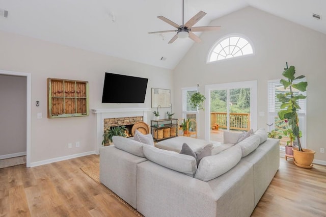 2045 Bethany Spring Trce, Cumming, GA 30041 - living room with a ceiling fan, light wood finished floors, high vaulted ceiling, and a stone fireplace