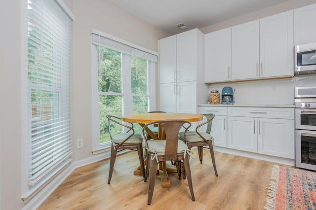 2045 Bethany Spring Trce, Cumming, GA 30041 - dining area featuring light wood finished floors