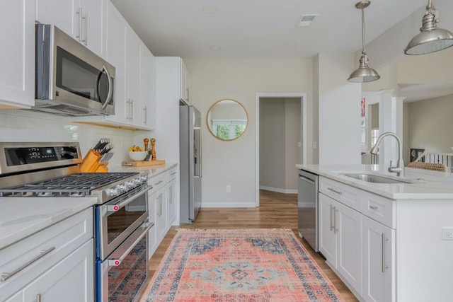 2045 Bethany Spring Trce, Cumming, GA 30041 - kitchen with stainless steel appliances, backsplash, white cabinets, and pendant lighting