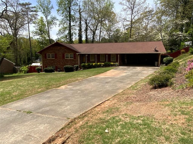 ranch-style home featuring a front lawn, an attached carport, and concrete driveway
