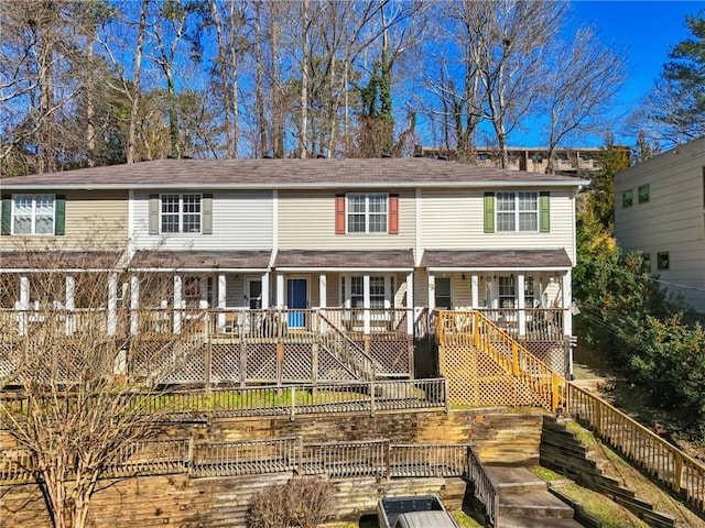 multi unit property with stairway and a wooden deck