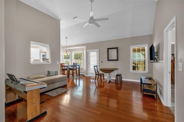 living room with visible vents, ceiling fan, wood finished floors, high vaulted ceiling, and baseboards