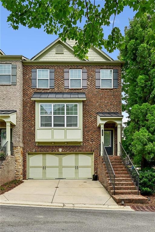 view of property featuring concrete driveway, an attached garage, and brick siding