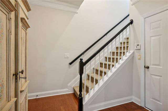 stairway featuring baseboards and wood finished floors