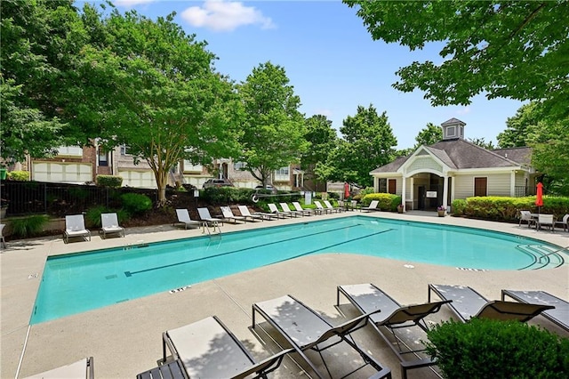 community pool featuring a patio area and fence