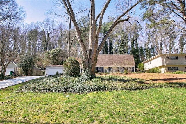 view of front of property featuring a garage and a front lawn