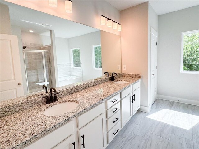 bathroom featuring tile flooring, plus walk in shower, and dual bowl vanity