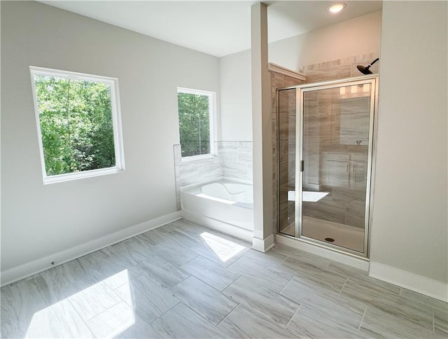 bathroom with tile floors and shower with separate bathtub