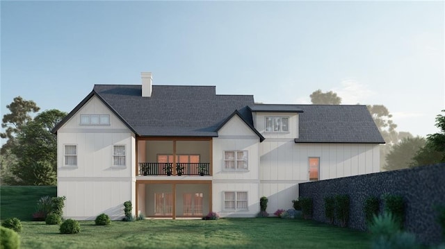 rear view of property featuring a balcony, fence, roof with shingles, a chimney, and a lawn