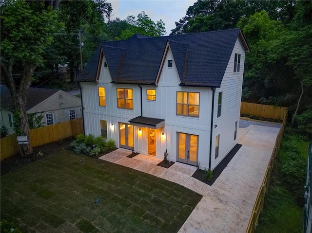 2809 Glenwood Ave SE, Atlanta, GA 30317 - back of property with french doors, a patio area, board and batten siding, and roof with shingles