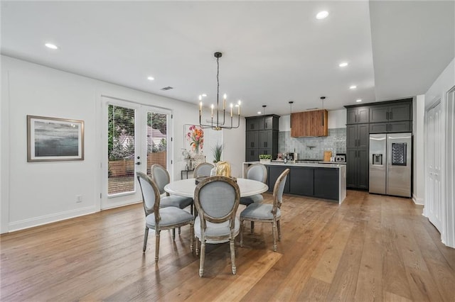 2809 Glenwood Ave SE, Atlanta, GA 30317 - dining space featuring light wood finished floors, recessed lighting, baseboards, french doors, and a chandelier