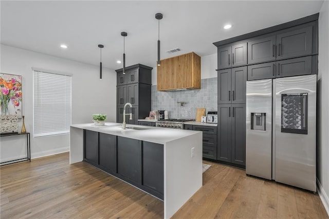 2809 Glenwood Ave SE, Atlanta, GA 30317 - kitchen with stainless steel appliances, a sink, light countertops, decorative backsplash, and recessed lighting