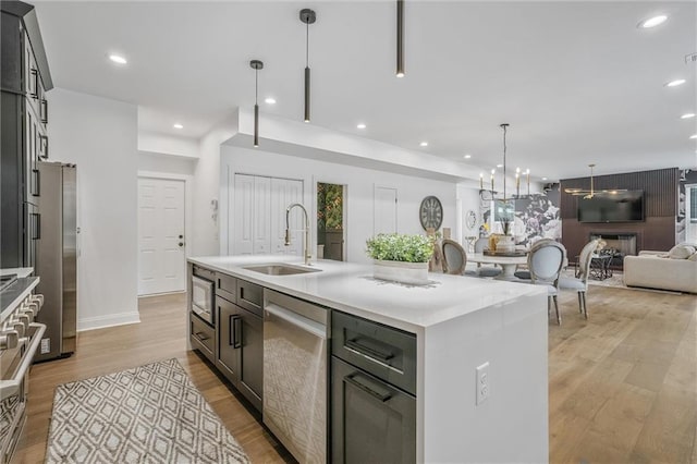 2809 Glenwood Ave SE, Atlanta, GA 30317 - kitchen with a sink, stainless steel appliances, light wood finished floors, light countertops, and recessed lighting