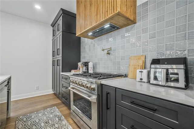 2809 Glenwood Ave SE, Atlanta, GA 30317 - kitchen with high end range, light countertops, light wood-style flooring, baseboards, and recessed lighting