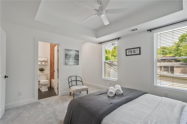 2809 Glenwood Ave SE, Atlanta, GA 30317 - bedroom featuring carpet, baseboards, ensuite bath, a tray ceiling, and a ceiling fan