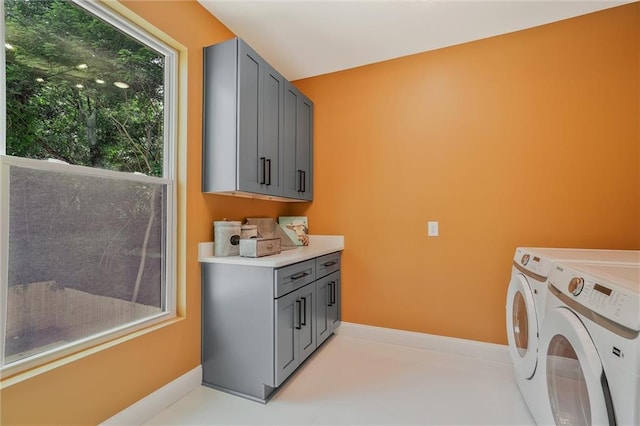 2809 Glenwood Ave SE, Atlanta, GA 30317 - laundry area with cabinet space, washer and clothes dryer, and baseboards