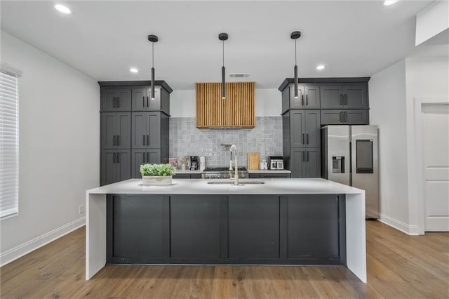 2809 Glenwood Ave SE, Atlanta, GA 30317 - kitchen with stainless steel fridge with ice dispenser, a sink, light countertops, baseboards, and decorative backsplash