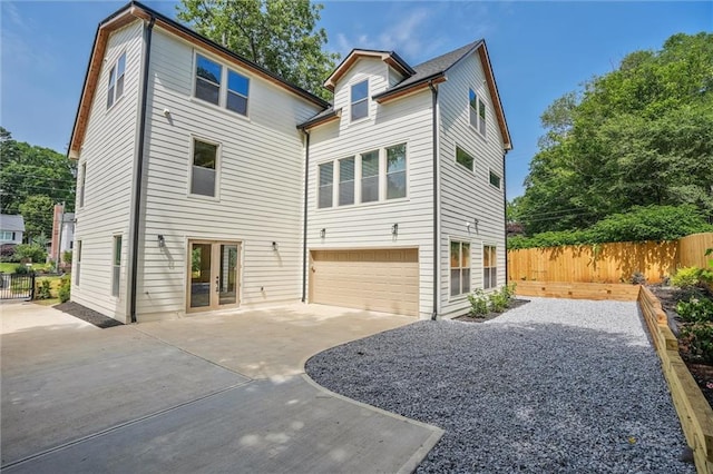 2809 Glenwood Ave SE, Atlanta, GA 30317 - rear view of property featuring driveway, a garage, and a patio area