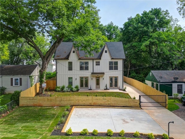 2809 Glenwood Ave SE, Atlanta, GA 30317 - modern farmhouse style home featuring french doors, board and batten siding, a gate, and roof with shingles