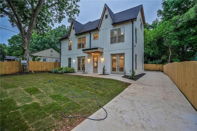 2809 Glenwood Ave SE, Atlanta, GA 30317 - view of front of house with french doors, board and batten siding, concrete driveway, and a shingled roof