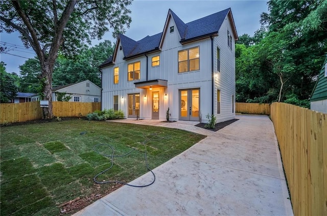 2809 Glenwood Ave SE, Atlanta, GA 30317 - view of front facade with french doors, driveway, board and batten siding, roof with shingles, and a patio area