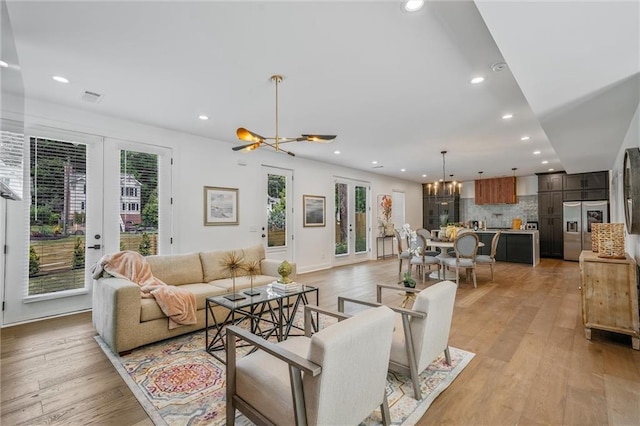 2809 Glenwood Ave SE, Atlanta, GA 30317 - living room featuring a chandelier, recessed lighting, plenty of natural light, and light wood-style floors