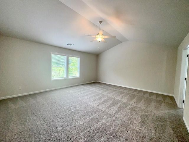 carpeted empty room with ceiling fan and lofted ceiling