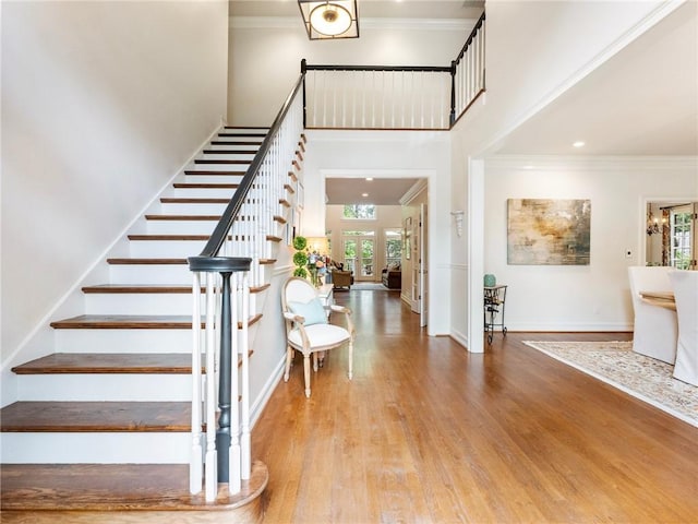 350 Fountain Oaks Ln, Atlanta, GA 30342 - staircase with wood finished floors, crown molding, and a high ceiling