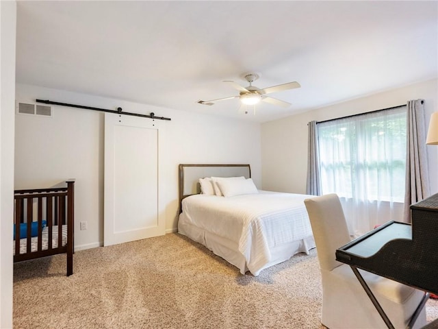 350 Fountain Oaks Ln, Atlanta, GA 30342 - bedroom featuring a barn door, light carpet, and a ceiling fan