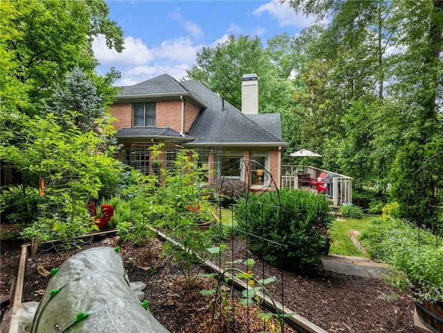 350 Fountain Oaks Ln, Atlanta, GA 30342 - rear view of property featuring a chimney, brick siding, a shingled roof, and a wooden deck