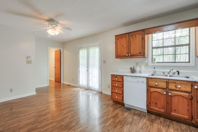 798 Tommy Lee Cook Rd, Palmetto, GA 30268 - kitchen with dishwasher, brown cabinets, light wood-style floors, ceiling fan, and plenty of natural light