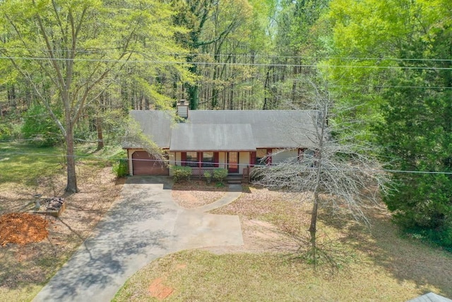 798 Tommy Lee Cook Rd, Palmetto, GA 30268 - view of front of home with covered porch, driveway, a chimney, and a forest view