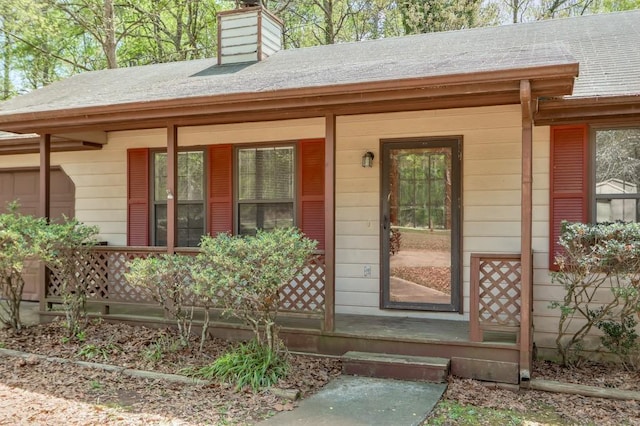 798 Tommy Lee Cook Rd, Palmetto, GA 30268 - entrance to property with a porch, roof with shingles, and a chimney