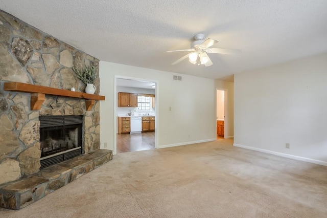 798 Tommy Lee Cook Rd, Palmetto, GA 30268 - unfurnished living room featuring a stone fireplace, a ceiling fan, light colored carpet, and a textured ceiling
