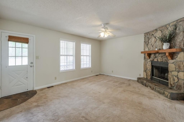 798 Tommy Lee Cook Rd, Palmetto, GA 30268 - unfurnished living room featuring ceiling fan, carpet flooring, a fireplace, and a textured ceiling