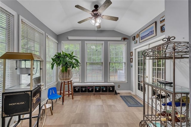 sunroom with baseboards and vaulted ceiling