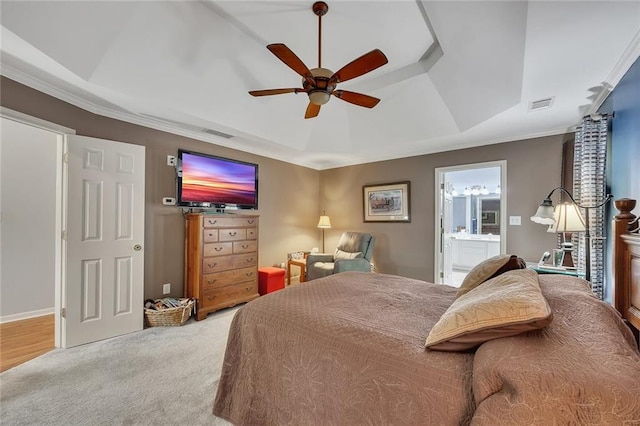 bedroom featuring visible vents, a raised ceiling, connected bathroom, ornamental molding, and carpet flooring