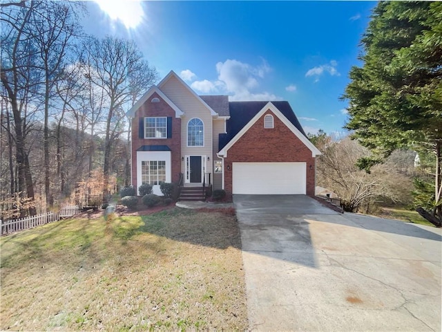 traditional-style home featuring a front lawn, fence, concrete driveway, an attached garage, and brick siding